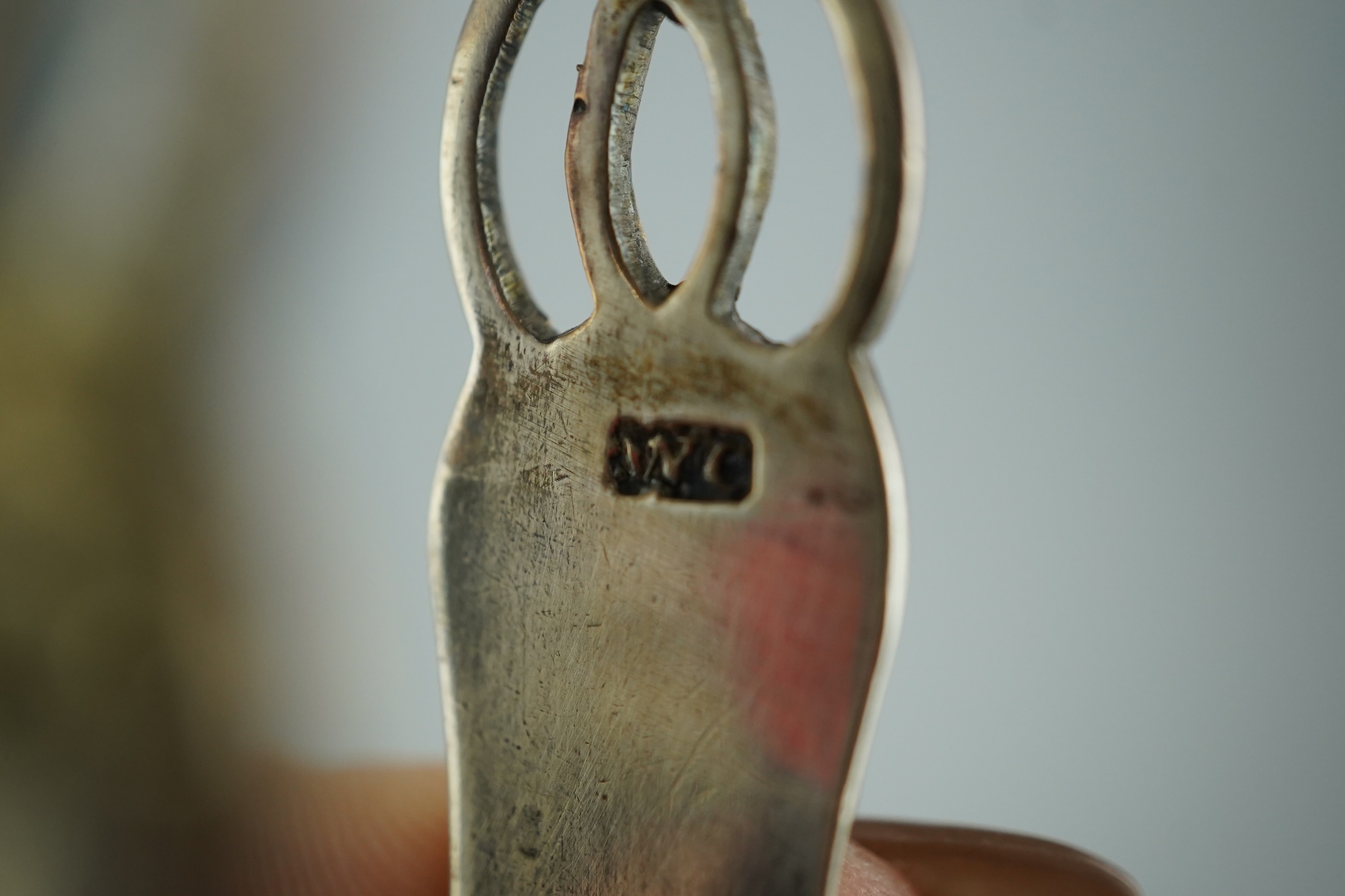 A pair of George III pierced silver tongs, makers mark only WC (repair), 13.1cm. Condition - poor